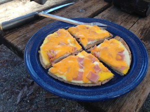 A camping breakfast favorite, eggs, ham, and cheese on pita bread.